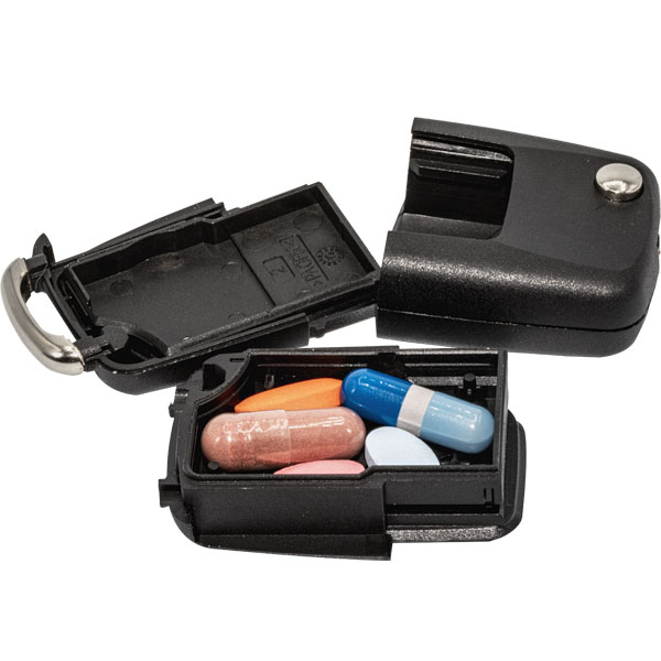 Open car key diversion safe revealing the hidden storage compartment with pills inside.